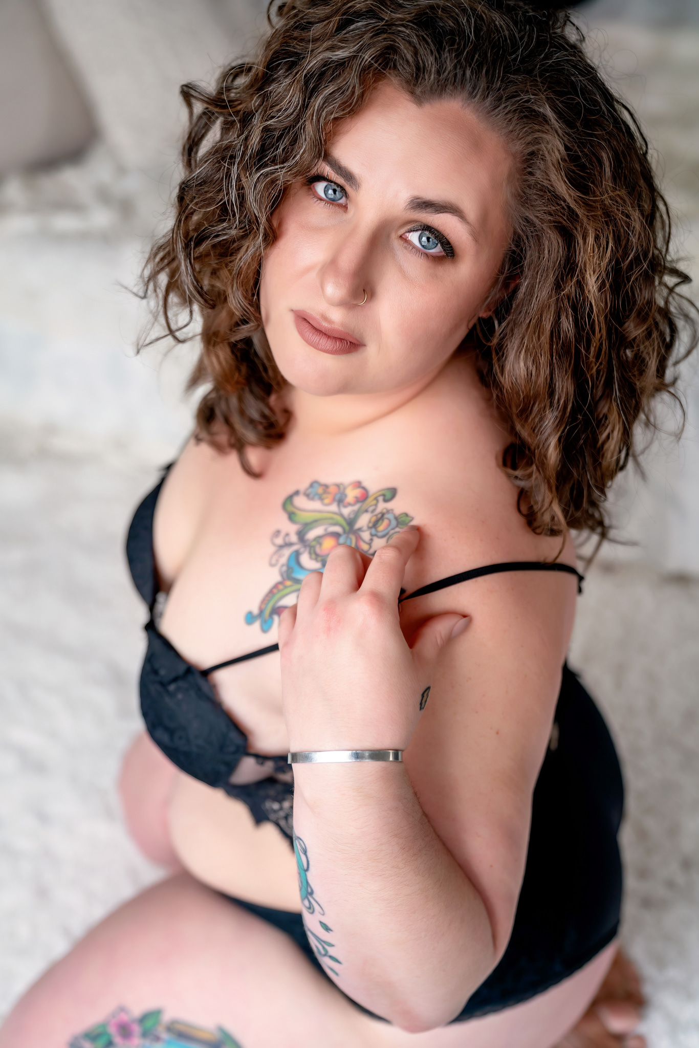 woman with tattoos in black lingerie kneeling on a white rug Spas in St. Charles